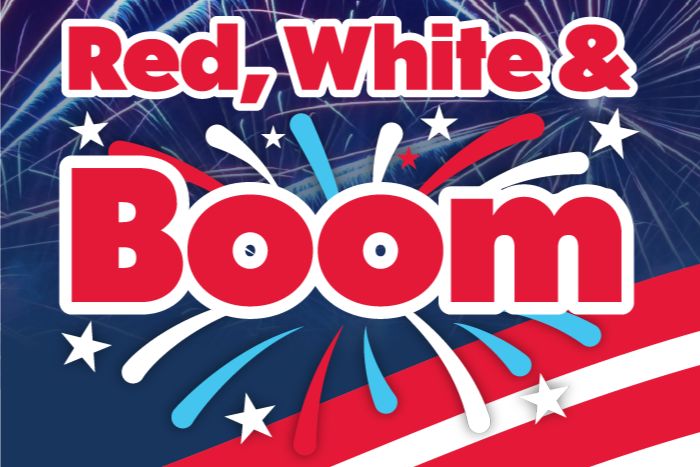 Colorful fireworks explode against a dark sky, accompanied by bold text that reads "Red, White & Boom," evoking a festive atmosphere celebrating a patriotic event, featured in the Prairie Farms MLB Tickets Sweepstakes