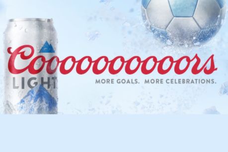 A chilled can of silver beer sits against a blue background, splashing water, with a soccer ball in the corner, evoking celebration and excitement for sports events, featured in the Coors Light $10,000 Sweepstakes