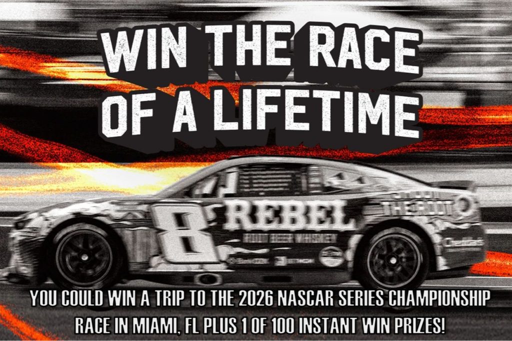A high-speed NASCAR race car is captured in motion, showcasing its sleek design and vibrant colors against a blurred background, emphasizing the thrill of the competition, featured in the Rebel Bourbon Suite Sweepstakes