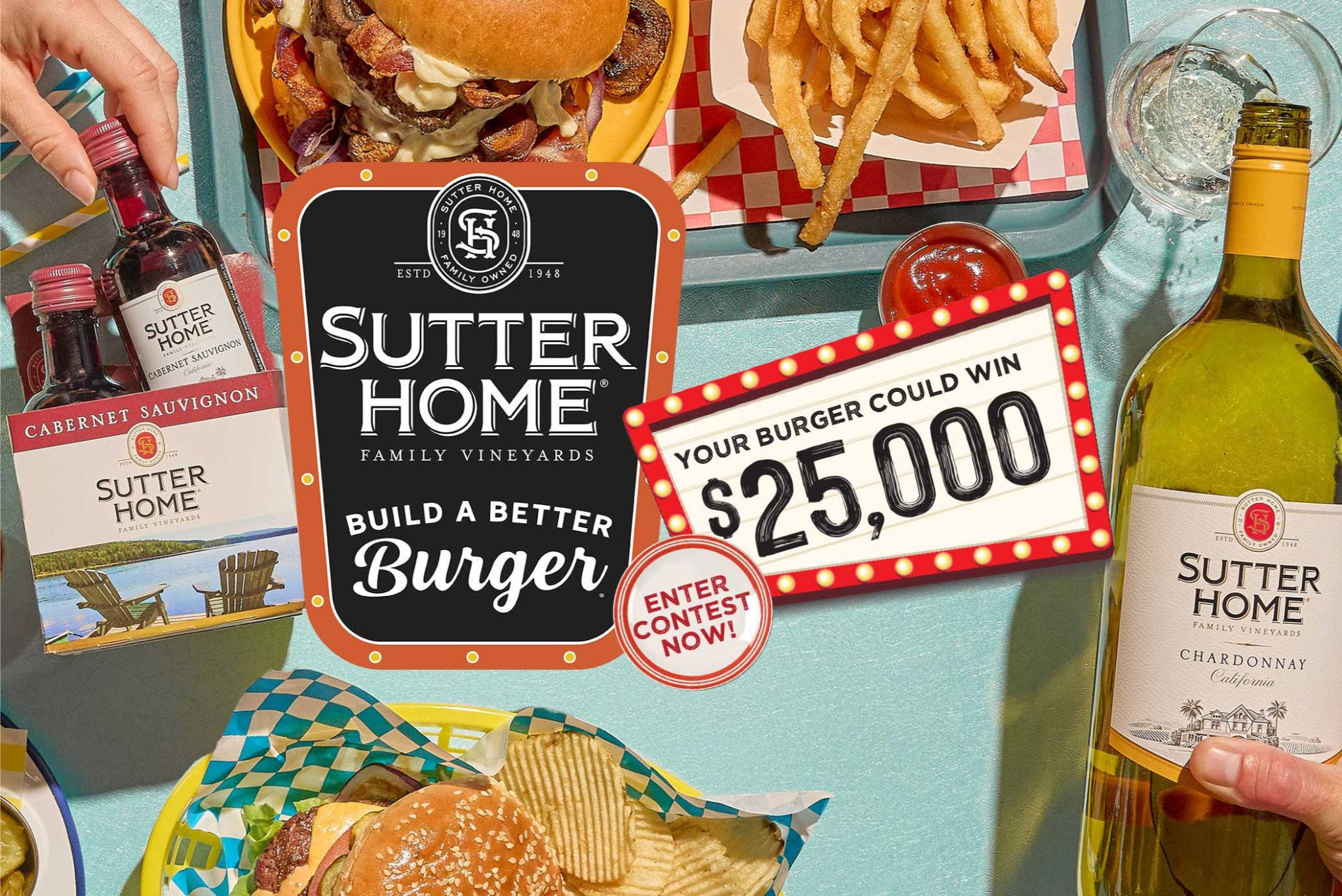 A vibrant tabletop scene features gourmet burgers, fries, and two bottles of wine. A contest sign suggests participants can win $25,000 by entering with their burger creations, featured in the Sutter Home Burger Recipe Contest