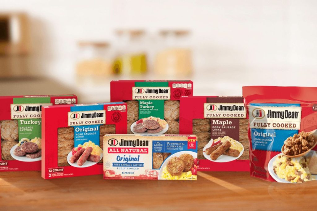 A variety of fully cooked sausage products are displayed on a kitchen countertop, showcasing different flavors and packaging from the same brand, featured in the Jimmy Dean Products for a Year Sweepstakes