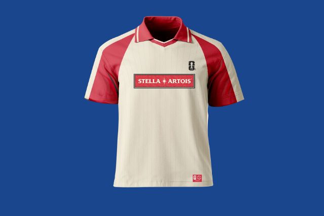 A light-colored athletic jersey with red sleeves and collar, featuring a central logo and branding, displayed against a blue background, featured in the Stella Artois Jersey Sweepstakes