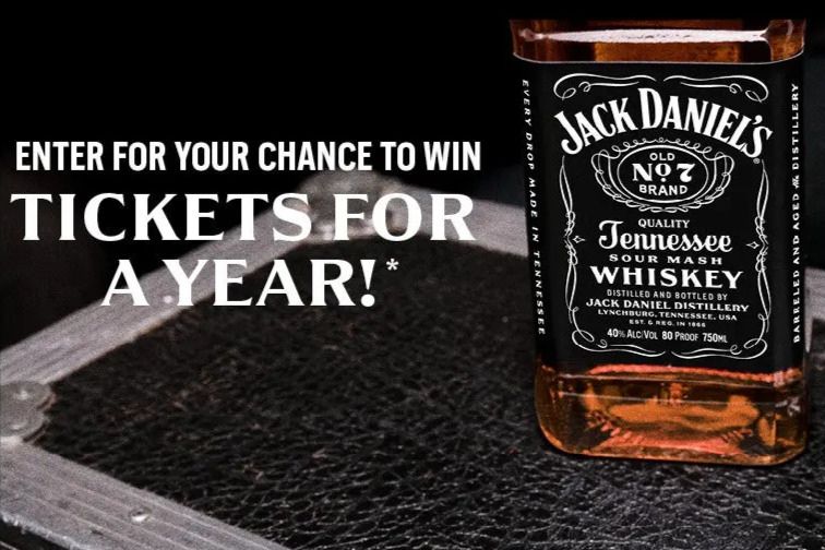 A bottle of Jack Daniel's Tennessee whiskey is prominently displayed on a dark surface, with a text overlay promoting a chance to win tickets for a year, featured in the Jack Daniel's Tickets for a Year Sweepstakes