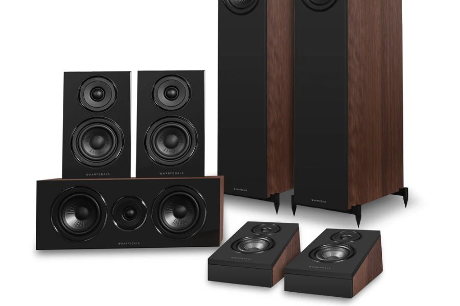 A collection of sleek, modern speakers in various sizes, featuring a glossy black front and wooden sides, arranged for optimal audio setup, featured in the Audio Advice Sweepstakes
