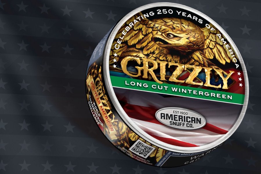 A round container of wintergreen flavored chewing tobacco featuring an eagle emblem and vibrant colors against a dark background with star patterns, featured in the Grizzly World Championship Sweepstakes