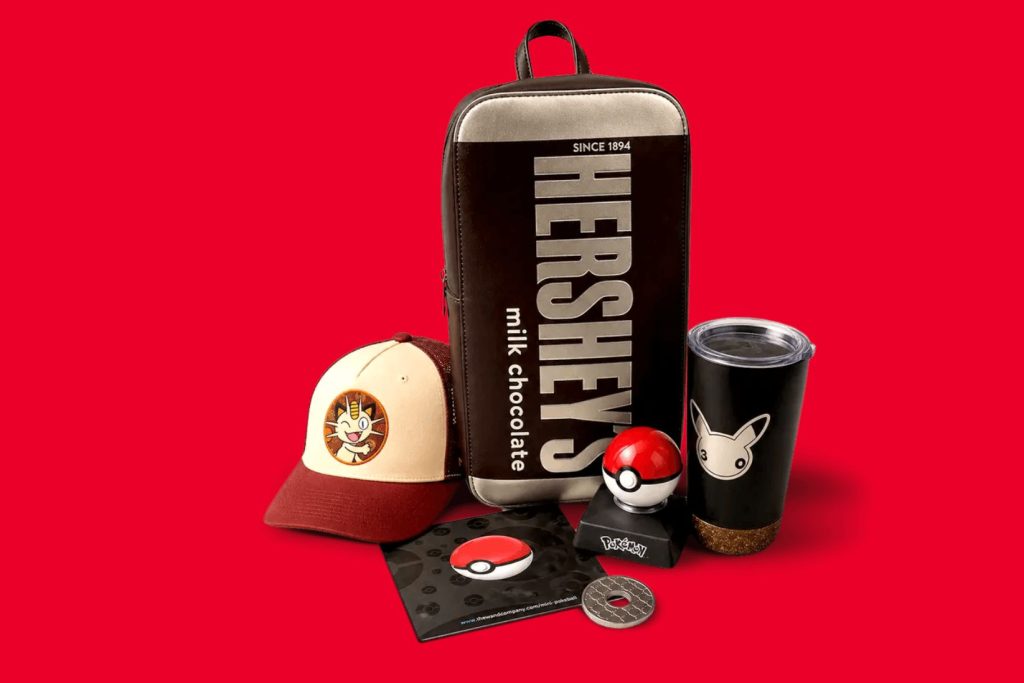 A collection of themed merchandise features a backpack, cap, Pokéball, cup, and a notebook, all set against a bold red background, featured in the Hershey Pokemon Sweepstakes